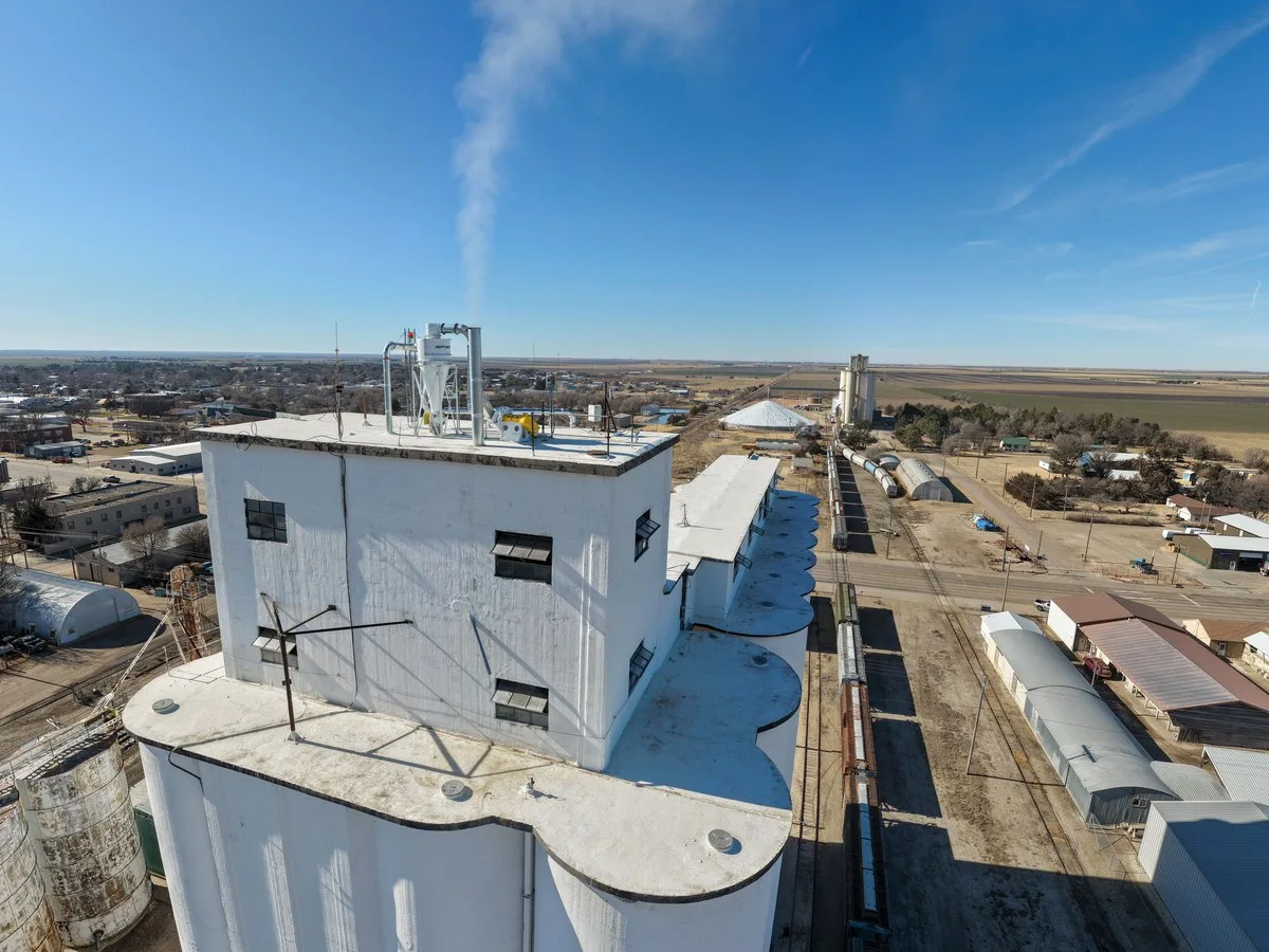 Western Kansas plains and grain elevator — rural communities facing water infrastructure stress